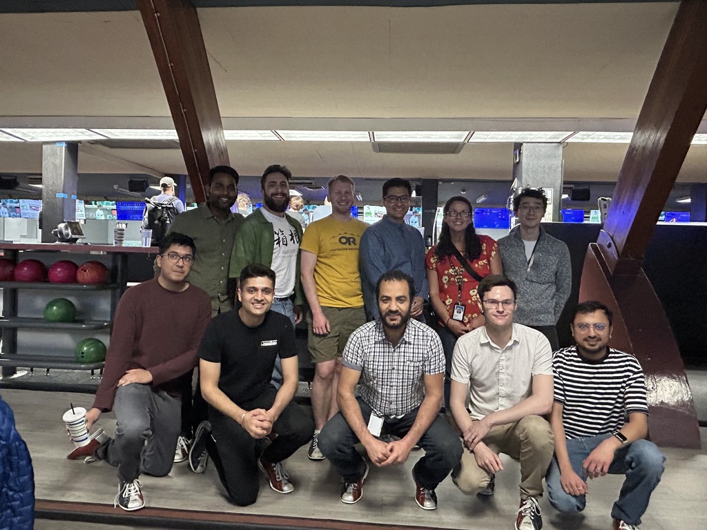 Qualtrics employees pose for a group photo at a team bowling activity.