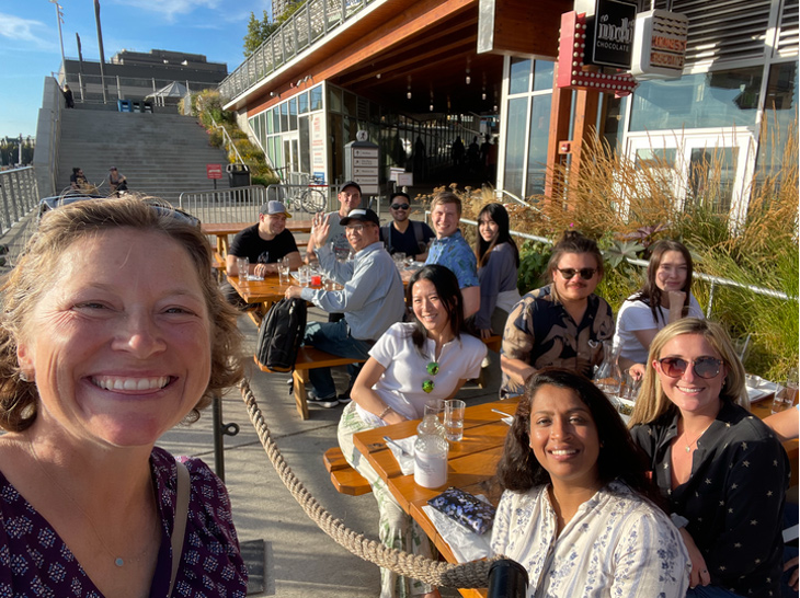 Qualtrics team photo at an outdoor restaurant