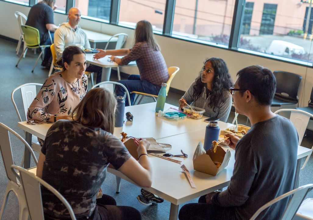 people seated around a table eating